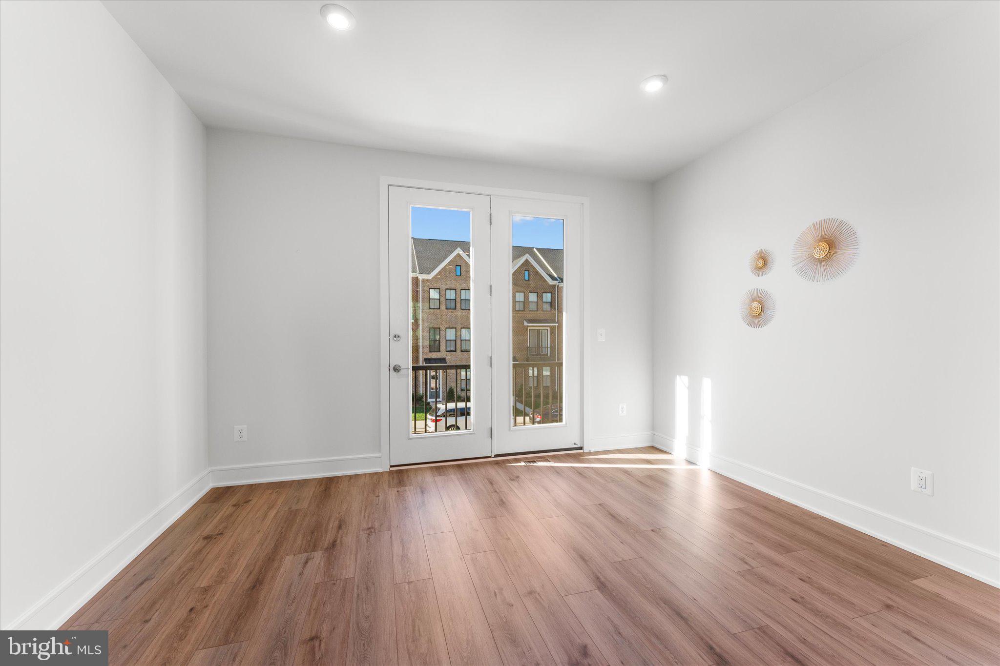 23080 Soaring Hts Terrace Ashburn, VA 20148 - Photo 13 of 44 an empty room with wooden floor and windows