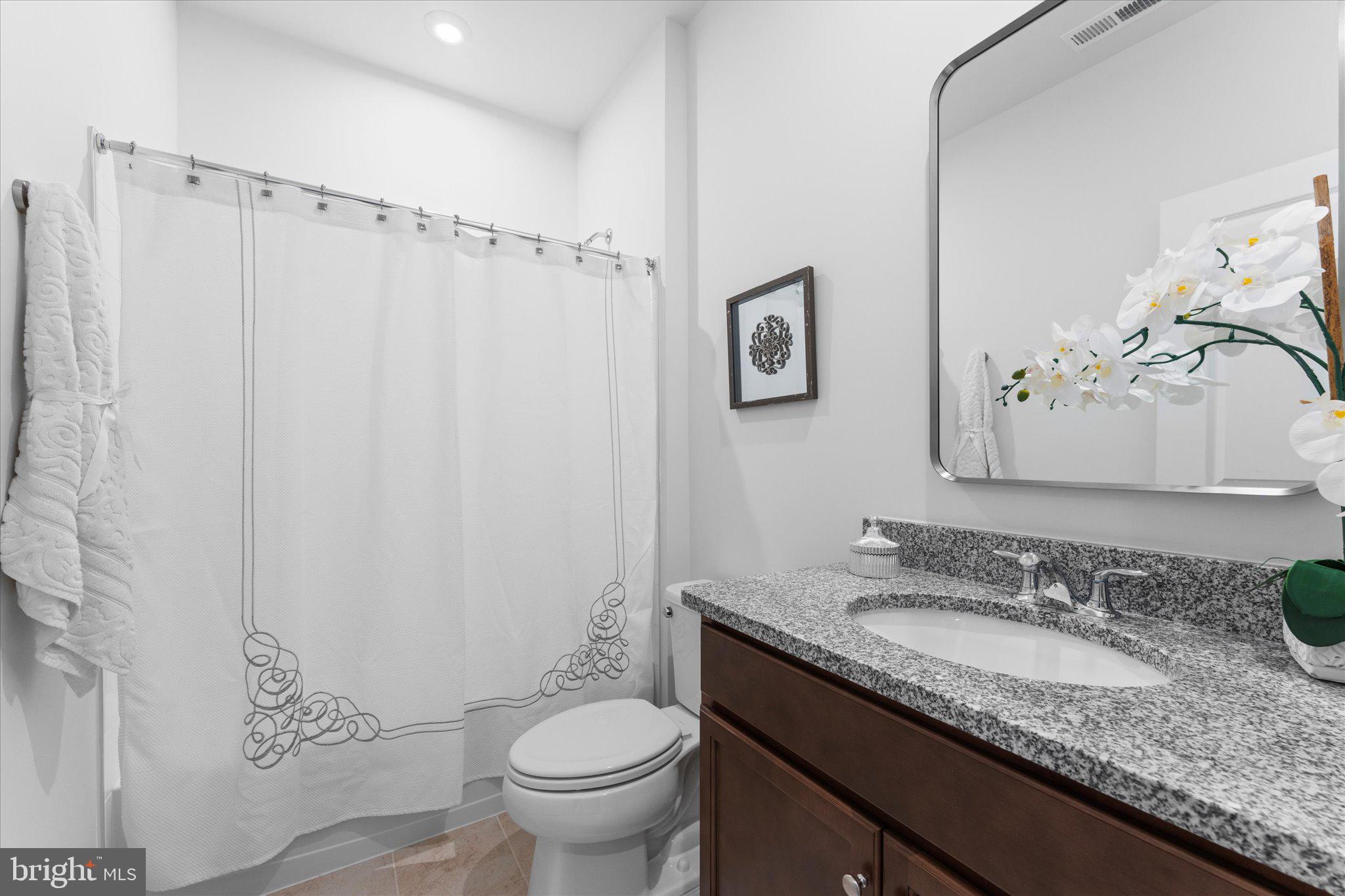 23080 Soaring Hts Terrace Ashburn, VA 20148 - Photo 17 of 44 a bathroom with a granite countertop sink toilet and shower