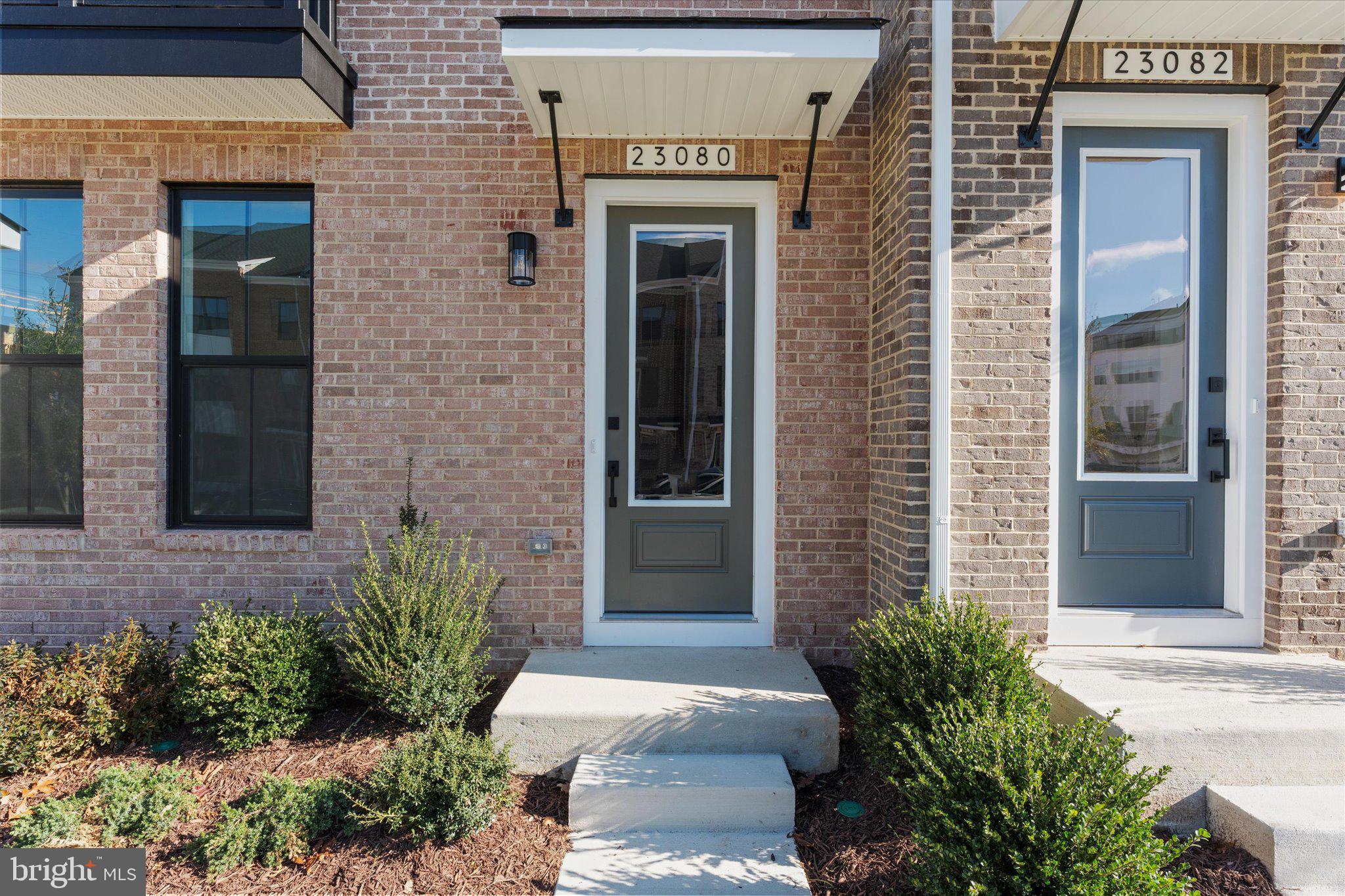 23080 Soaring Hts Terrace Ashburn, VA 20148 - Photo 2 of 44 a front view of a house with a garden