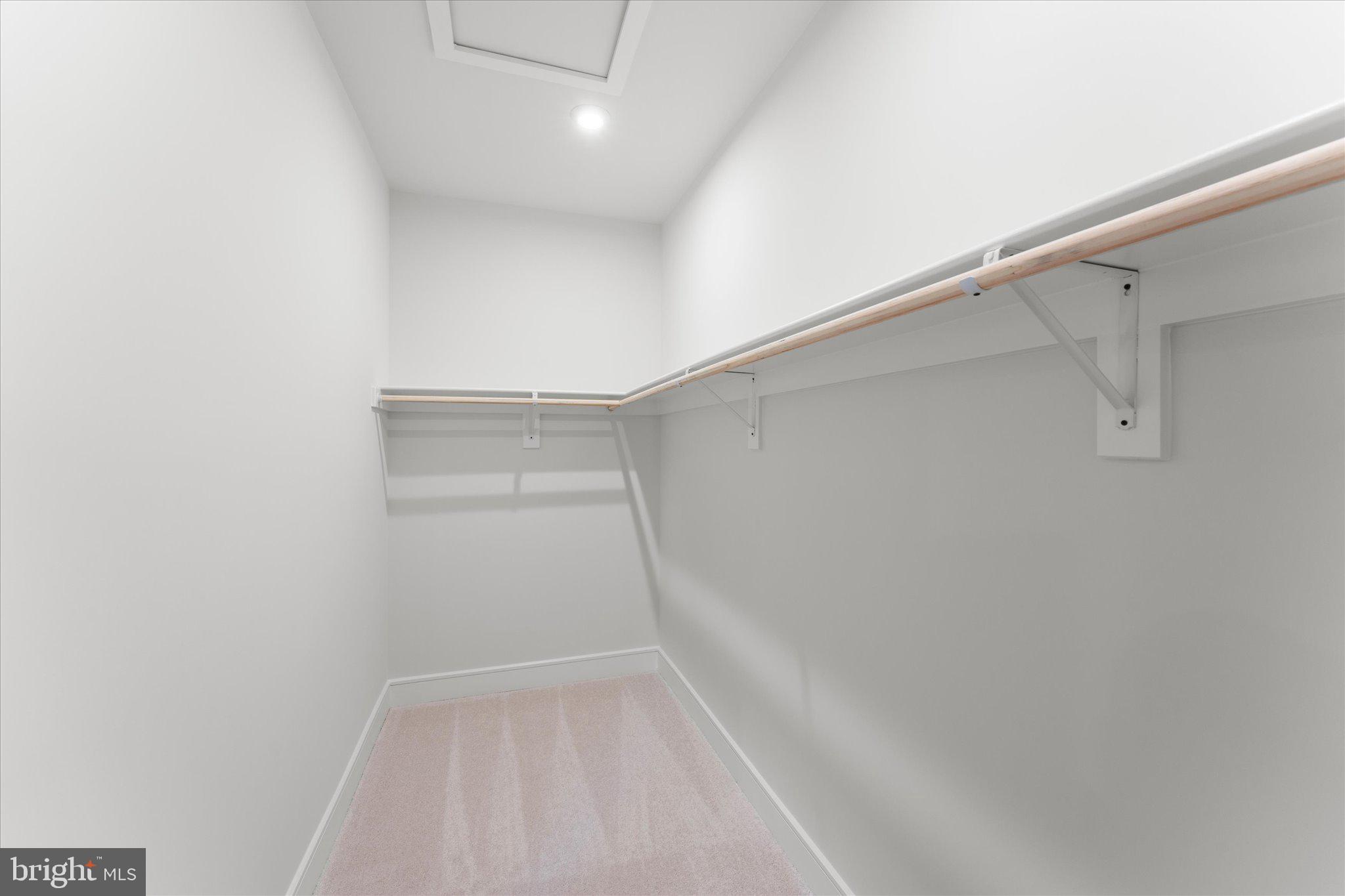 23080 Soaring Hts Terrace Ashburn, VA 20148 - Photo 30 of 44 a view of walk in closet with empty racks