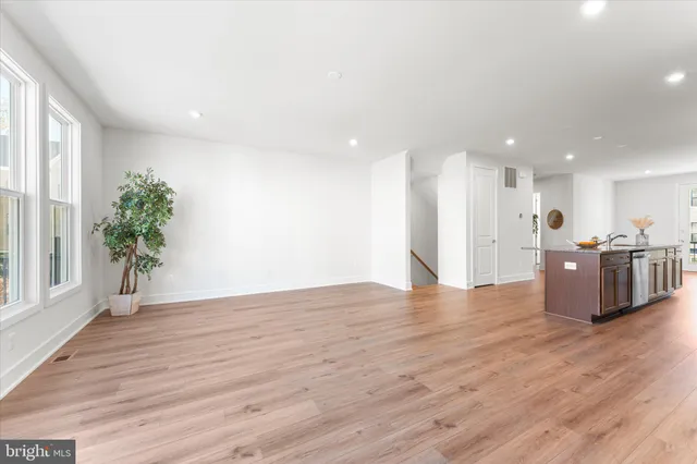 a kitchen with stainless steel appliances granite countertop a refrigerator a sink dishwasher a stove with wooden floors and cabinets