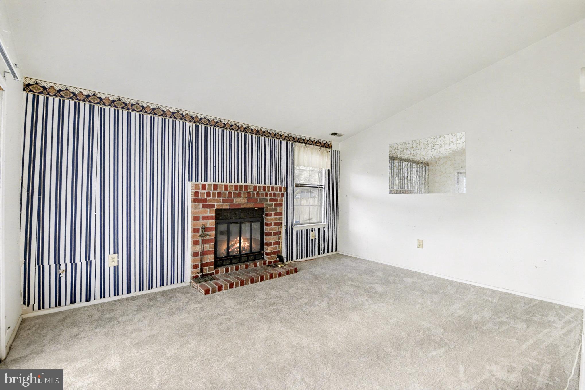 308 Laburnum Road Edgewood, MD 21040 - Photo 12 of 28 an empty room with fireplace and windows