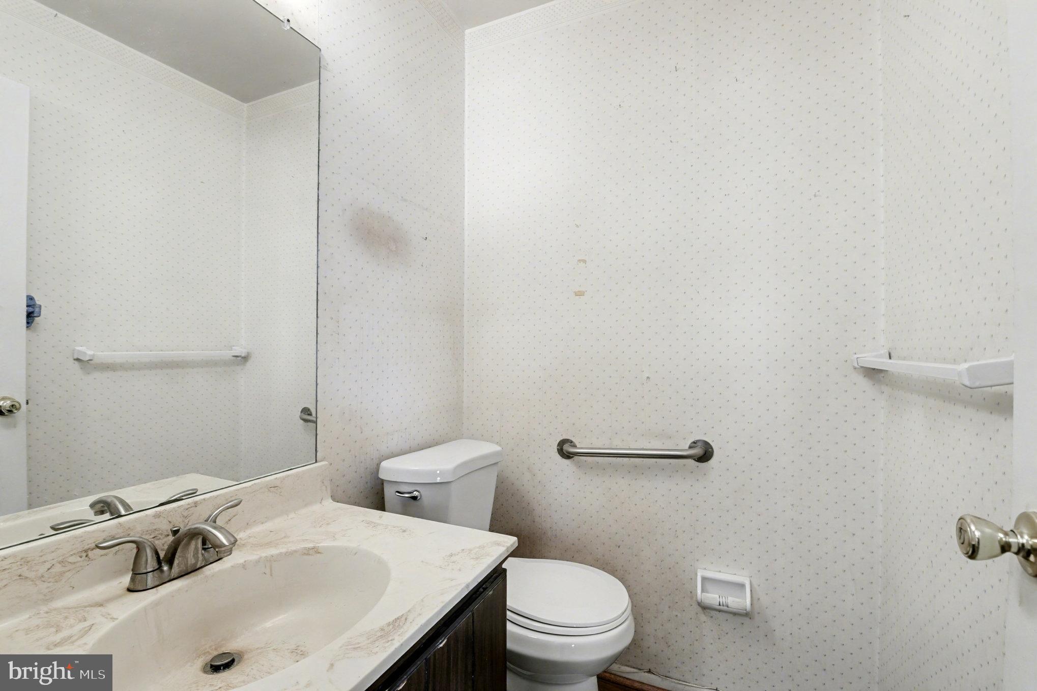 308 Laburnum Road Edgewood, MD 21040 - Photo 16 of 28 a white toilet sitting next to a bathroom sink