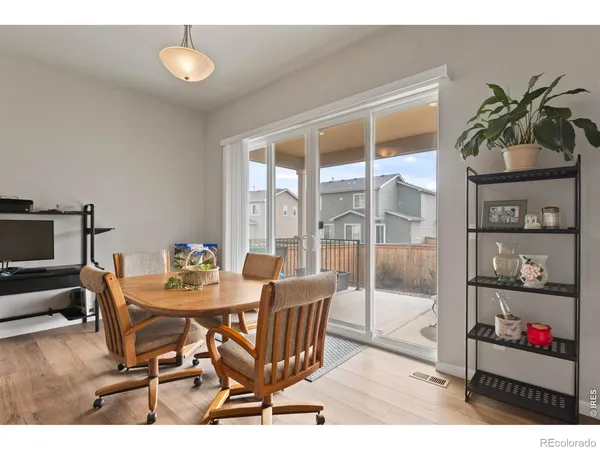 a dining room with furniture and a potted plant