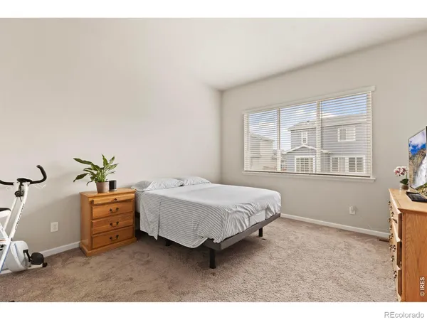 a bedroom with a bed and flat screen tv