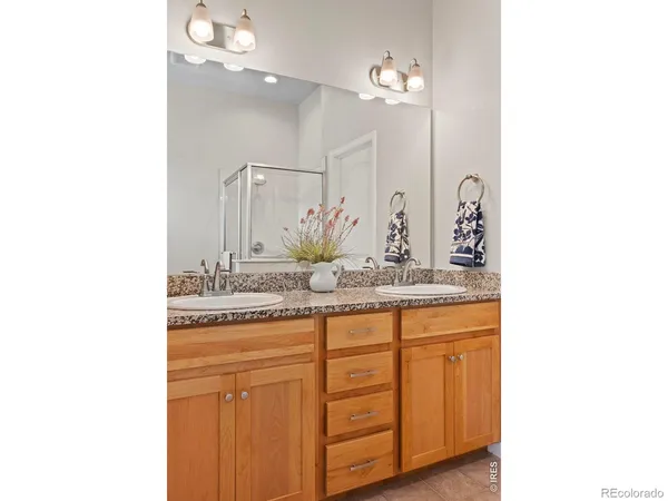 a bathroom with a granite countertop sink mirror and double