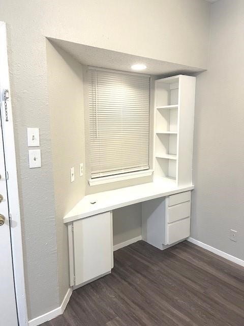 3316 Guadalupe Street, Unit 209 Austin, TX 78705 - Photo 3 of 12 Unfurnished office featuring built in desk, dark wood-type flooring, and a textured wall