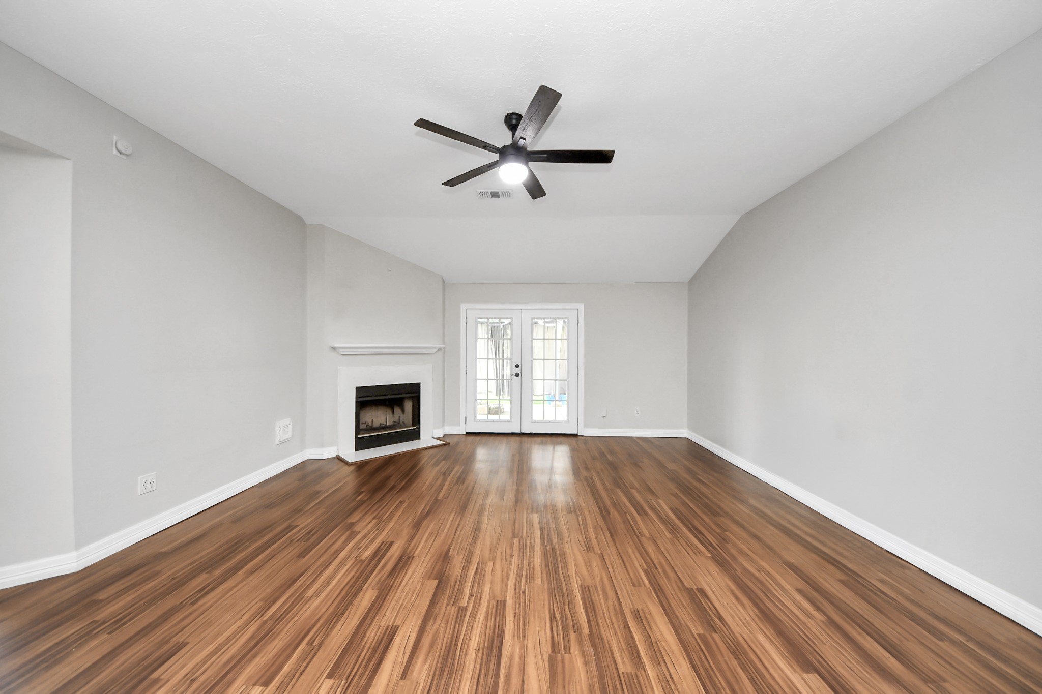 28707 Stapleford Street Spring, TX 77386 - Photo 7 of 38 a view of empty room with wooden floor fireplace and window
