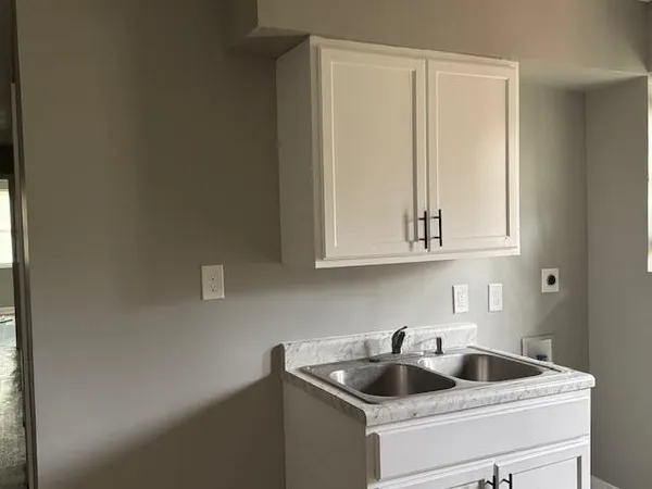 a kitchen with a sink and cabinets