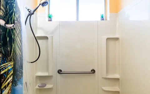 a bathroom with a mirror and a shower