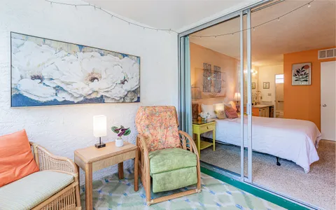 a bedroom with a bed and a painting on the wall