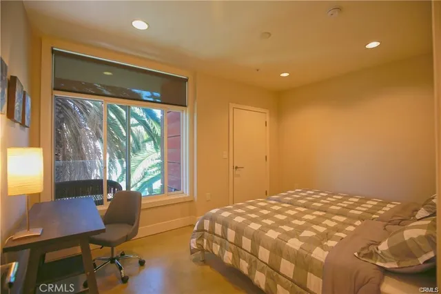 a bedroom with a bed and a desk