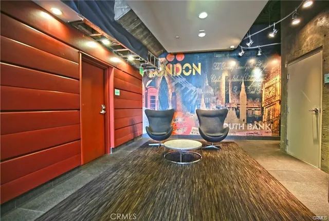 a view of a room with wooden floor and a potted plant