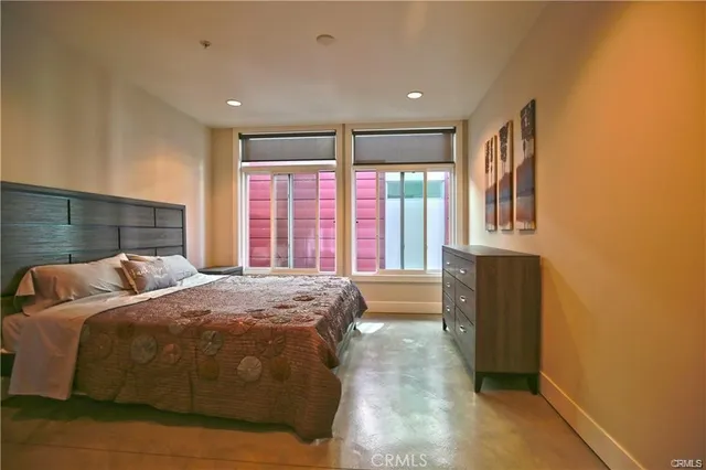 a bed sitting in a room next to a window