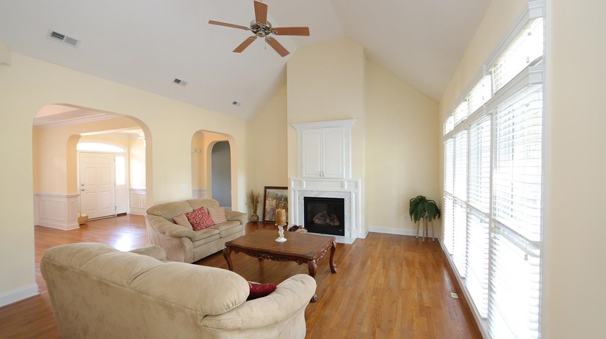 263 Waterville Street Raleigh, NC 27603 - Photo 7 of 23 Stunning Cathedral Ceiling with Abundant Natural Light. Great Backyard Views through Wall of Windows with Blinds throughout the home. Easy Care Hardwoods and Gas Fireplace Recently Serviced and Cleaned. Family Room