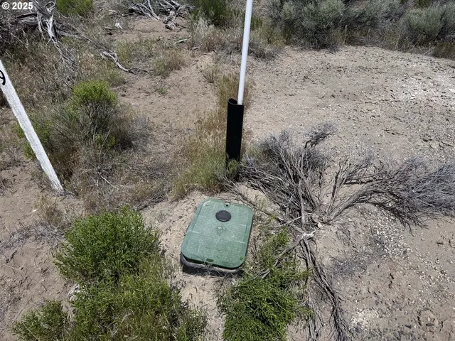 a view of a yard with wooden fence