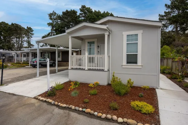 a front view of a house with a garden