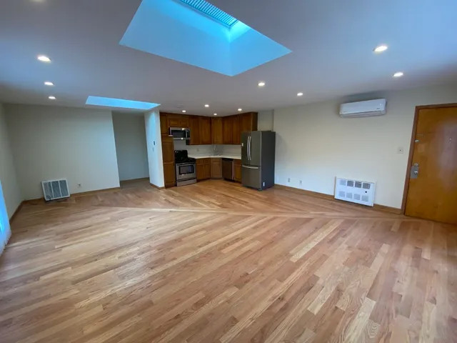 a view of a kitchen with a sink and a refrigerator