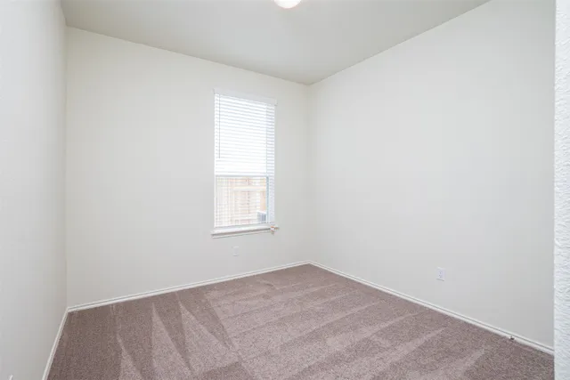 a view of an empty room with closet area