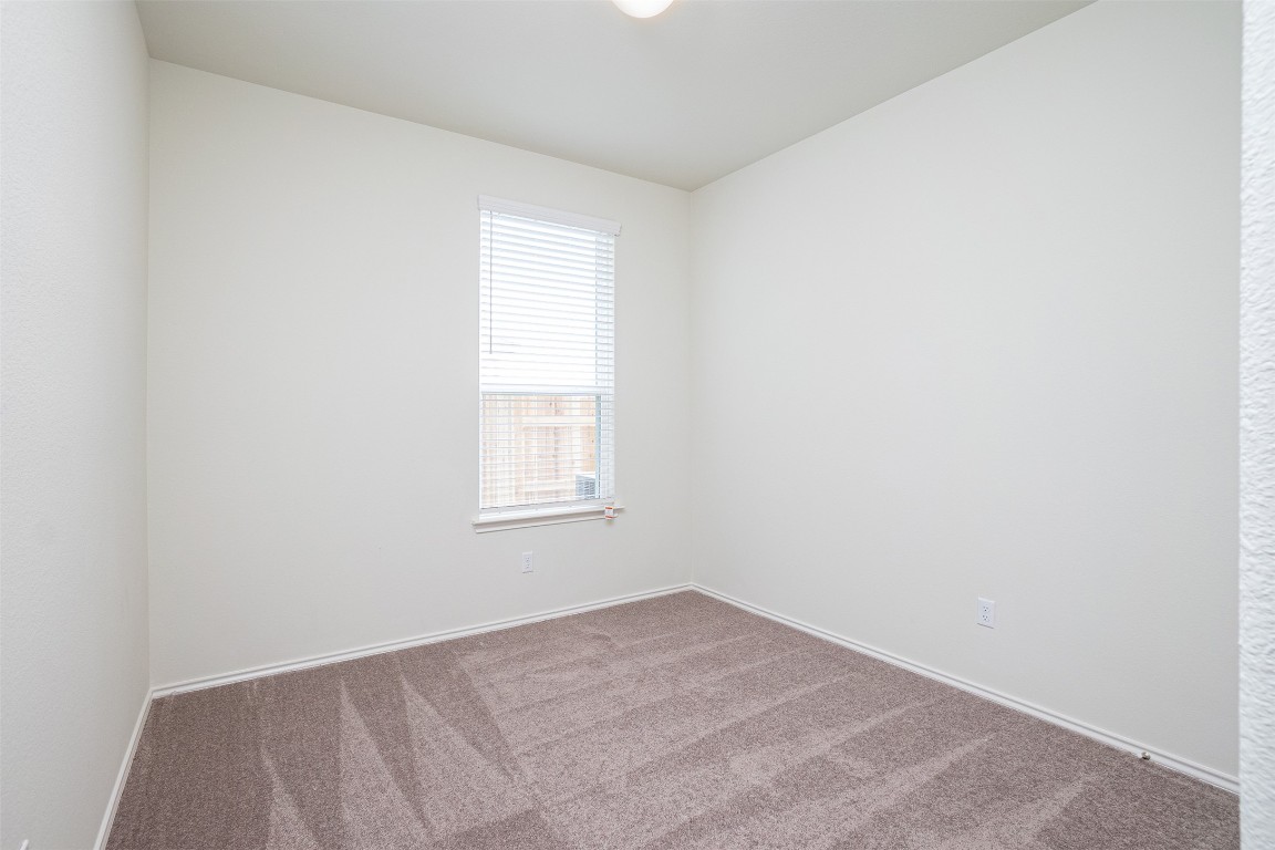237 Yellowbark Street Buda, TX 78610 - Photo 13 of 28 an empty room with a window