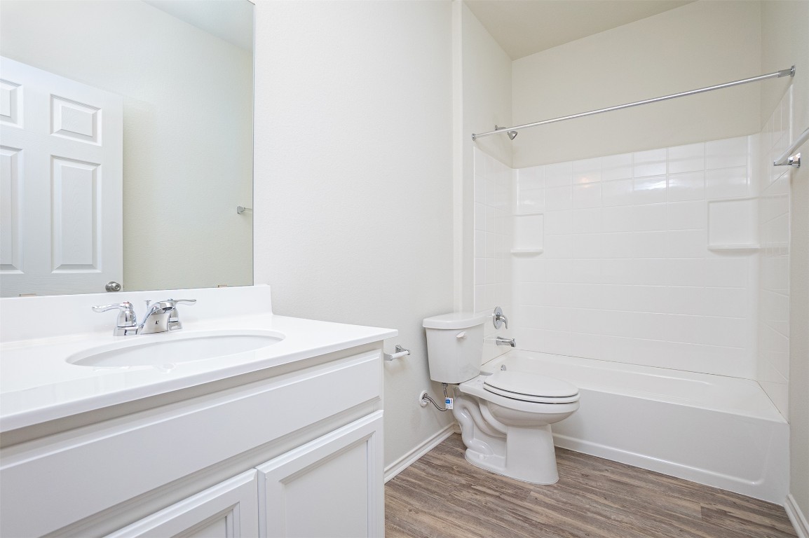 237 Yellowbark Street Buda, TX 78610 - Photo 14 of 28 a bathroom with a sink toilet and shower