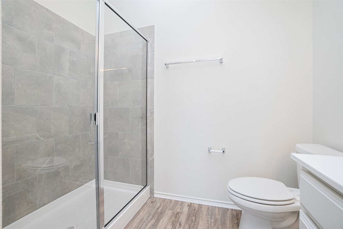 237 Yellowbark Street Buda, TX 78610 - Photo 18 of 28 a white toilet sitting next to a bath tub and shower