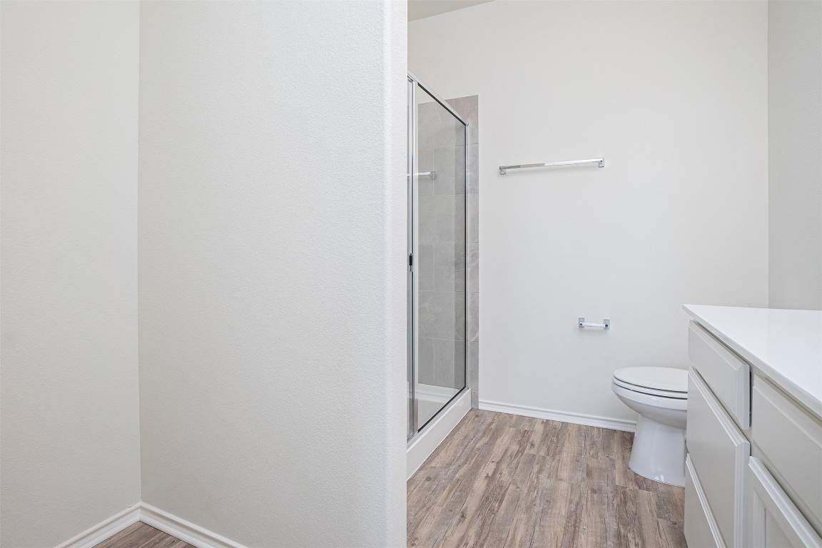 237 Yellowbark Street Buda, TX 78610 - Photo 19 of 28 a bathroom with a granite countertop toilet and a sink