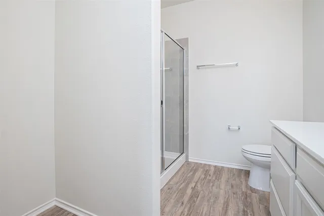 a bathroom with a toilet and a shower