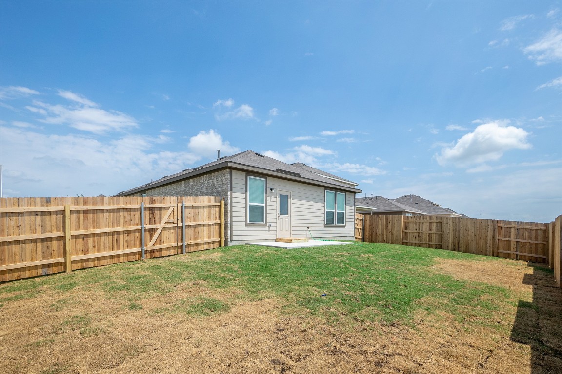 237 Yellowbark Street Buda, TX 78610 - Photo 21 of 28 a view of a house with a yard and wooden fence