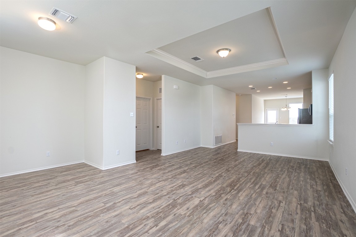 237 Yellowbark Street Buda, TX 78610 - Photo 28 of 28 a view of an empty room with wooden floor and a window
