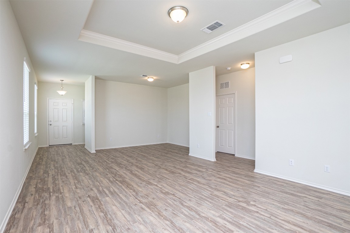237 Yellowbark Street Buda, TX 78610 - Photo 6 of 28 a view of an empty room and wooden floor