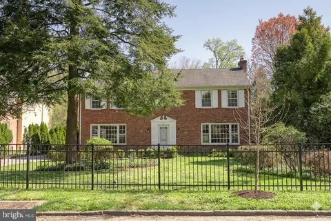 a view of a house with a backyard and a garden