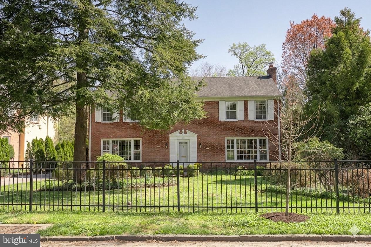 a view of a house with a backyard and a garden