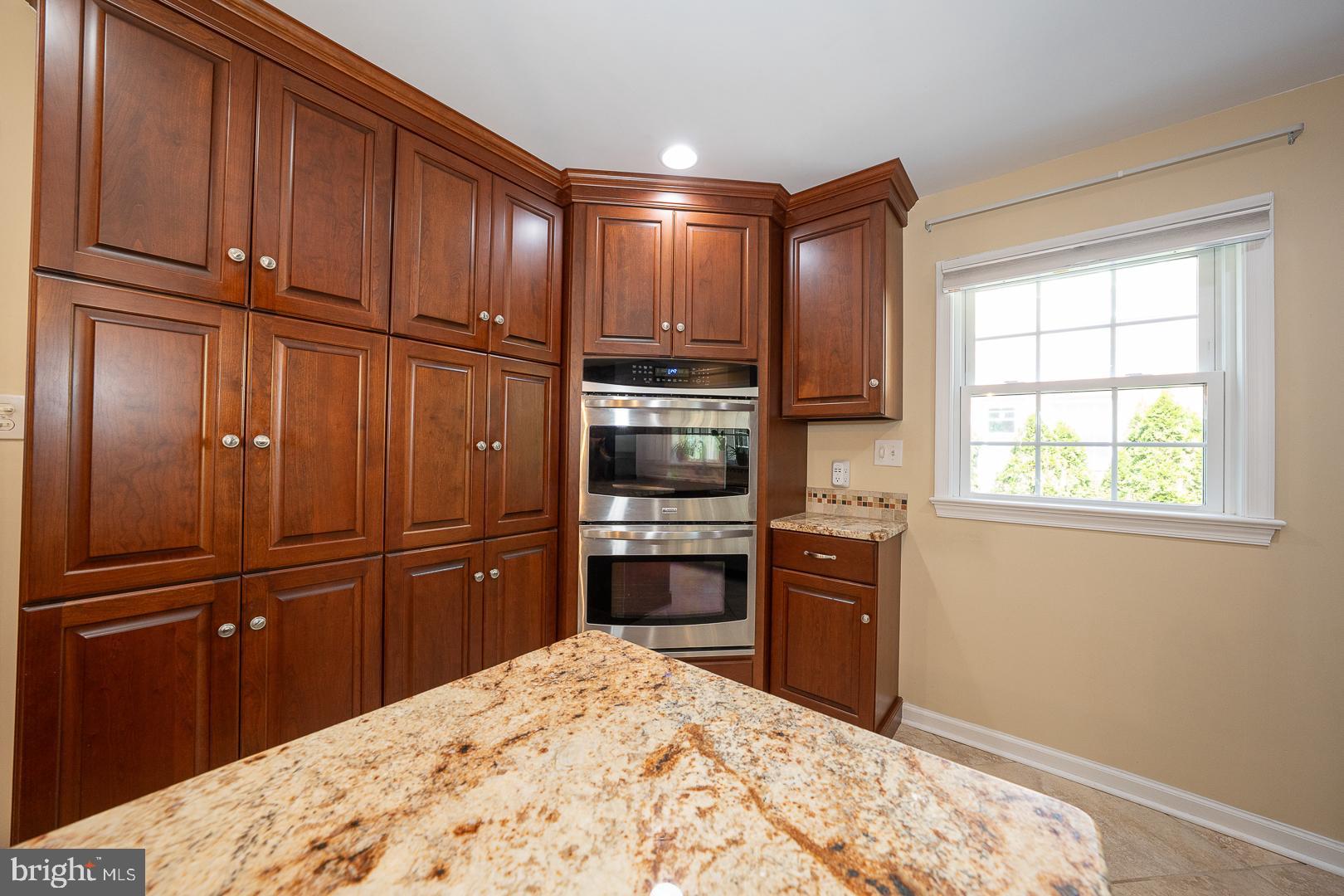 421 Wister Road Wynnewood, PA 19096 - Photo 12 of 53 a kitchen with granite countertop wooden cabinets and stainless steel appliances