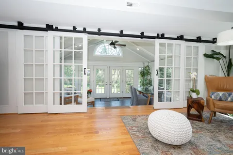 a living room with furniture and large windows