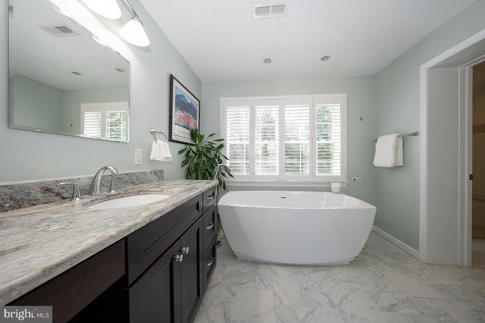 421 Wister Road Wynnewood, PA 19096 - Photo 26 of 53 a spacious bathroom with a tub sink and mirror