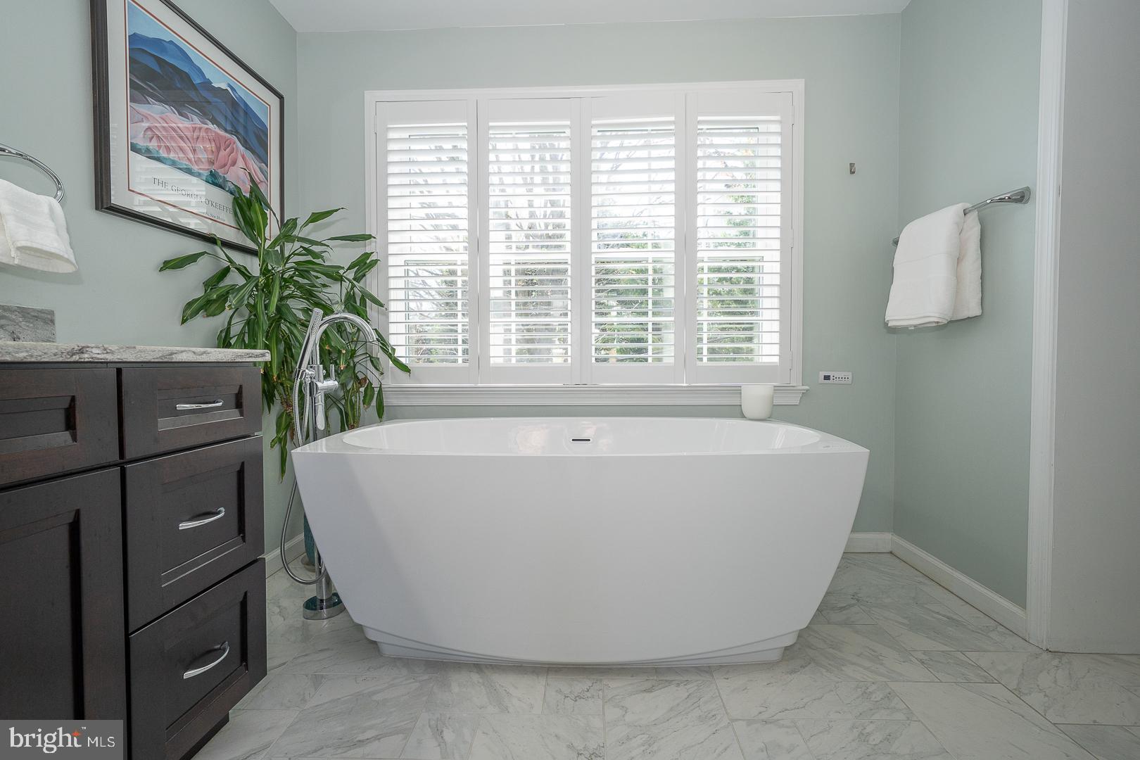 421 Wister Road Wynnewood, PA 19096 - Photo 27 of 53 a white bath tub sitting in a bathroom next to a window