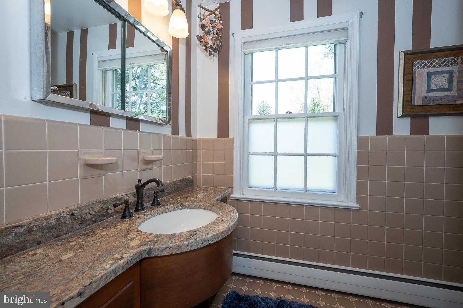421 Wister Road Wynnewood, PA 19096 - Photo 34 of 53 a bathroom with a granite countertop sink and a window