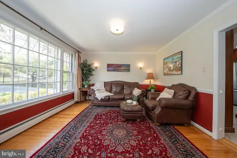 a dining room with furniture a rug and wooden floor