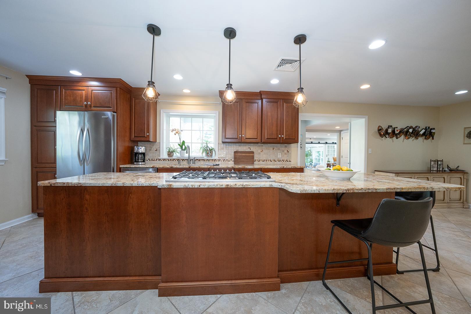 421 Wister Road Wynnewood, PA 19096 - Photo 10 of 53 a kitchen with kitchen island granite countertop a sink a center island and stainless steel appliances