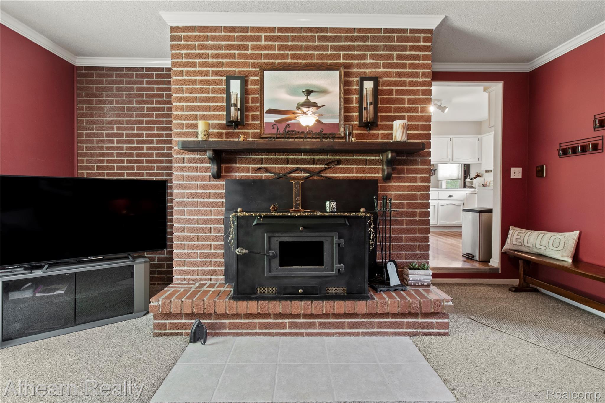 12427 Foley Road Fenton, MI 48430 - Photo 36 of 47 Brick fireplace with an integrated wood stove and a raised hearth