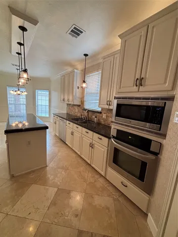 a view of an empty room with windows