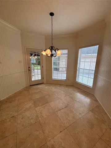 a bathroom with a granite countertop bathtub shower sink vanity and toilet