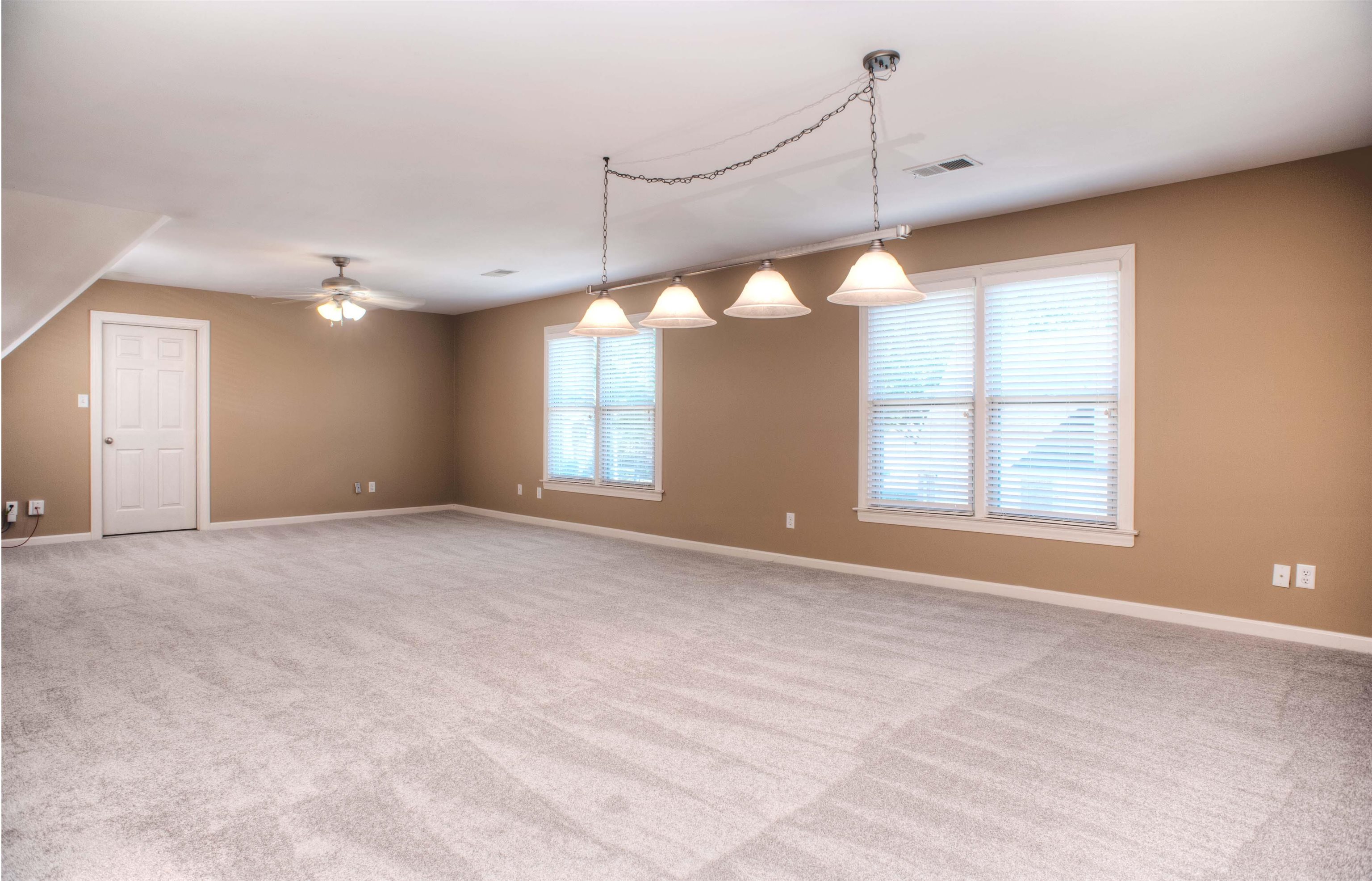495 Tribal Woods Road Collierville, TN 38017 - Photo 19 of 22 HUGE 30x16 Playroom Upstairs - also with New Carpet, Large Closet, and Access to Another Walk-In Attic