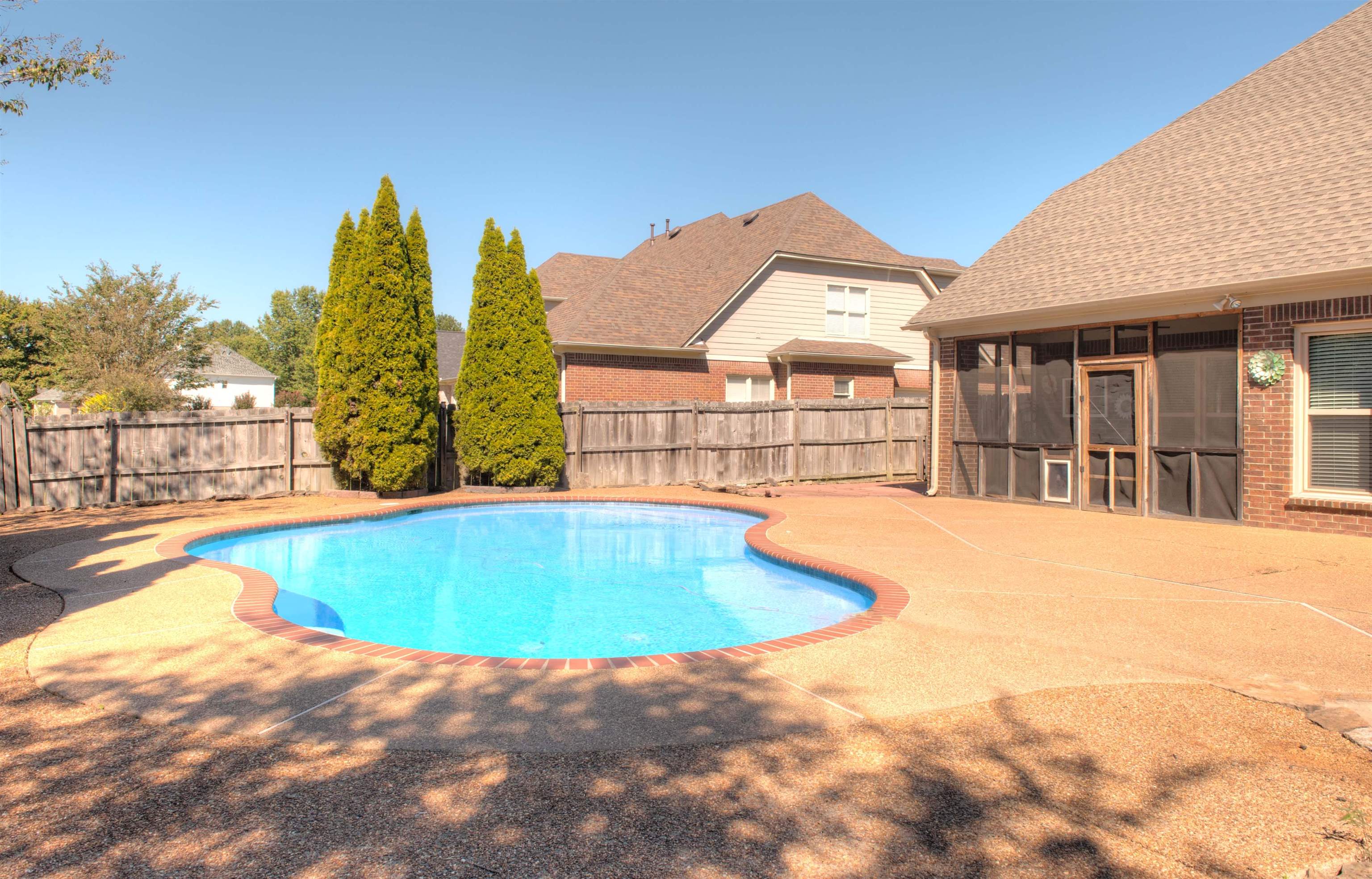 495 Tribal Woods Road Collierville, TN 38017 - Photo 21 of 22 Refreshing Gunite Pool in Wood Fenced Rear Yard with Screened Porch and Patios - PERFECT for Family Enjoyment and Entertaining!