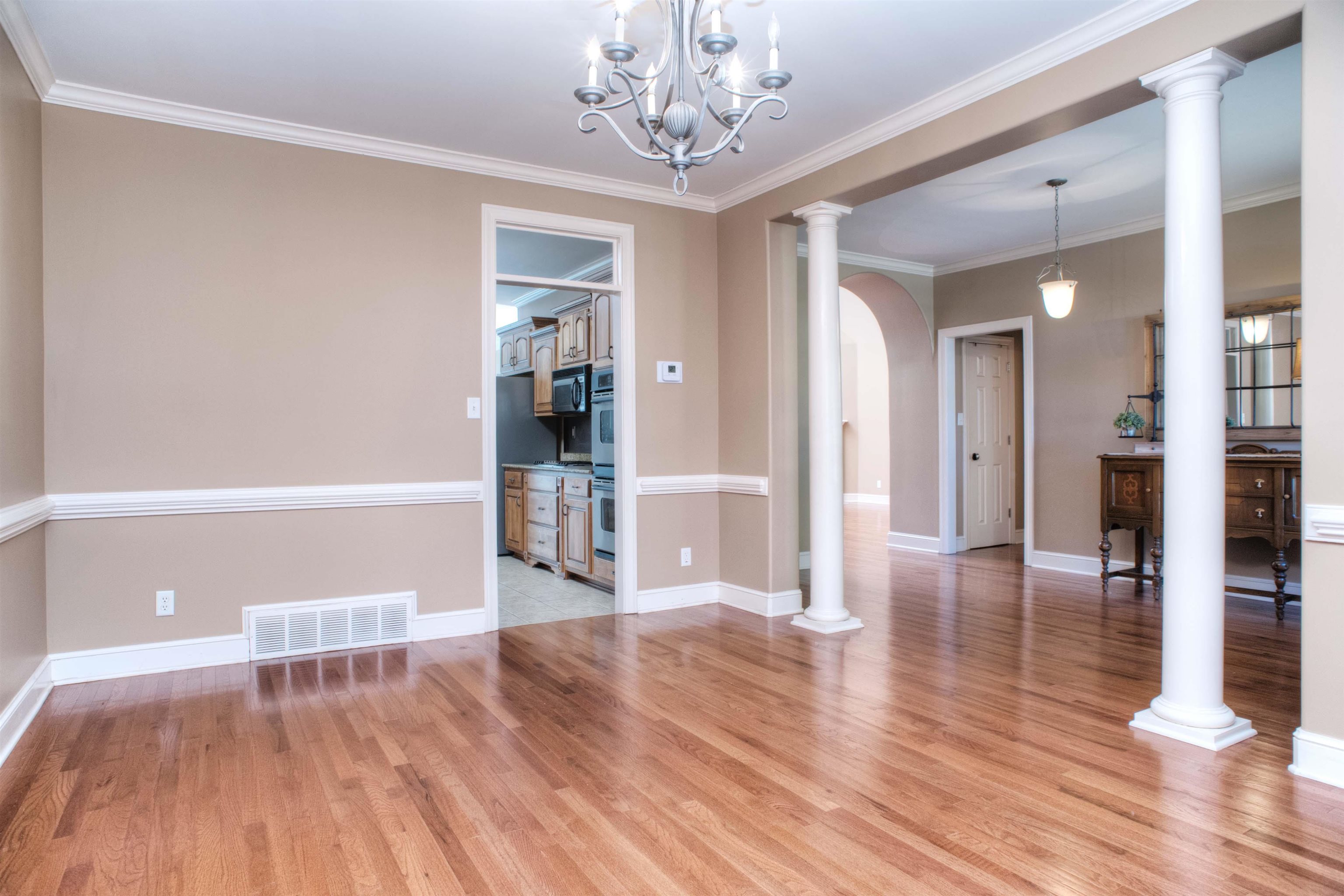 495 Tribal Woods Road Collierville, TN 38017 - Photo 3 of 22 Spacious 16x11 Dining Room also features Hardwood Floor, Crown and Chair Rail Molding and Columns right off the Entry