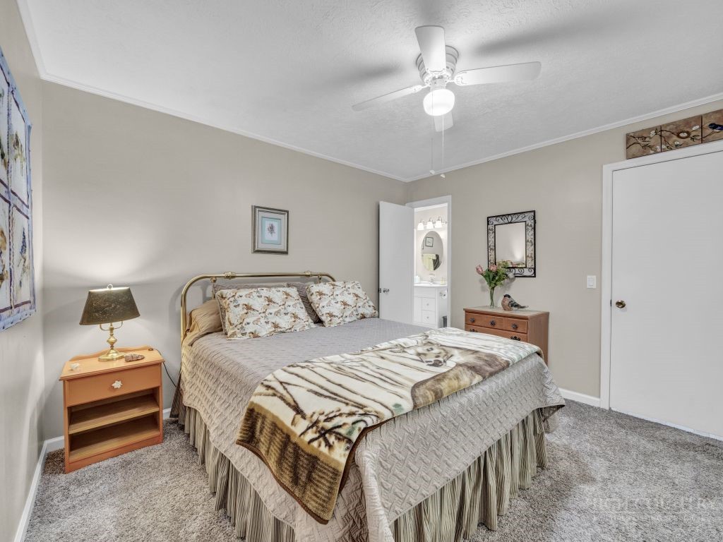 265 Trout Lake Road Deep Gap, NC 28618 - Photo 23 of 50 a bedroom with a bed and a chandelier