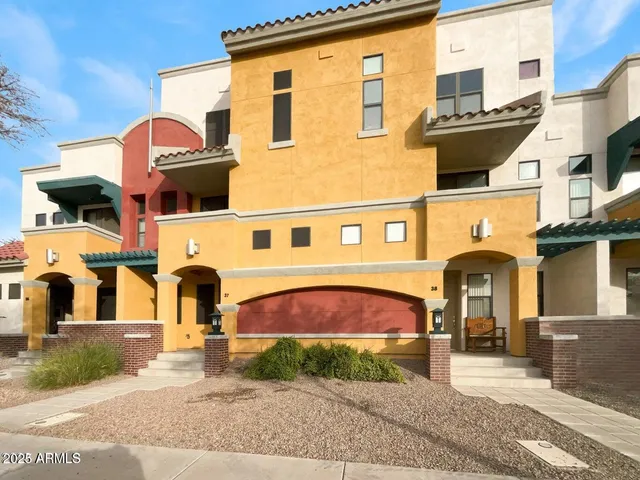 a front view of a residential apartment building with a yard