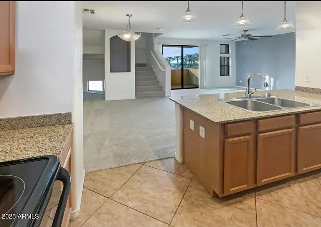 a kitchen with a sink stove and cabinets