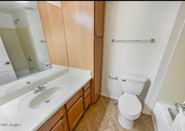 an empty room with windows and cabinet